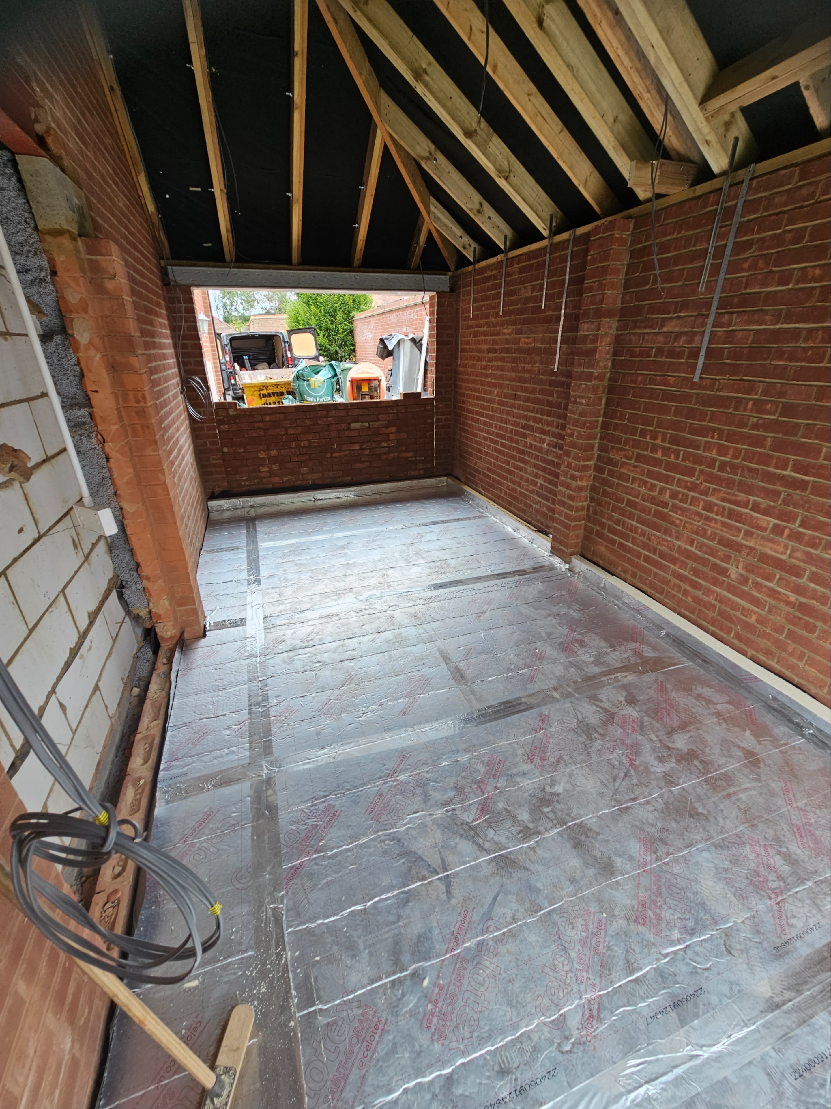 Completed garage conversion — finished interior with herringbone flooring
