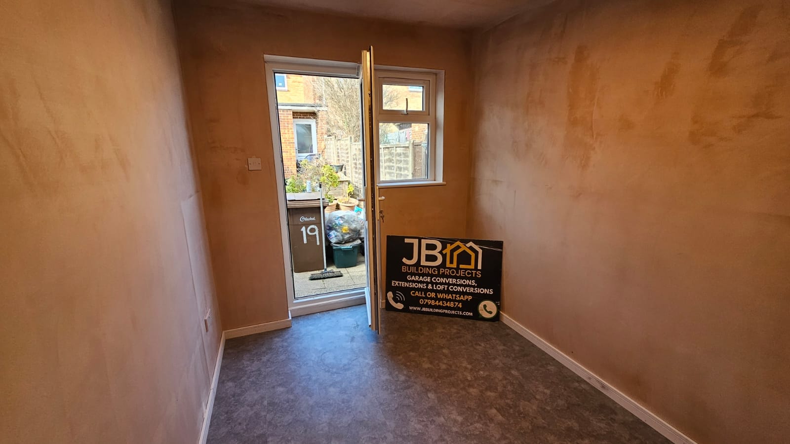 Finished interior of the Chelmsford partial garage conversion — insulated room with retained storage area