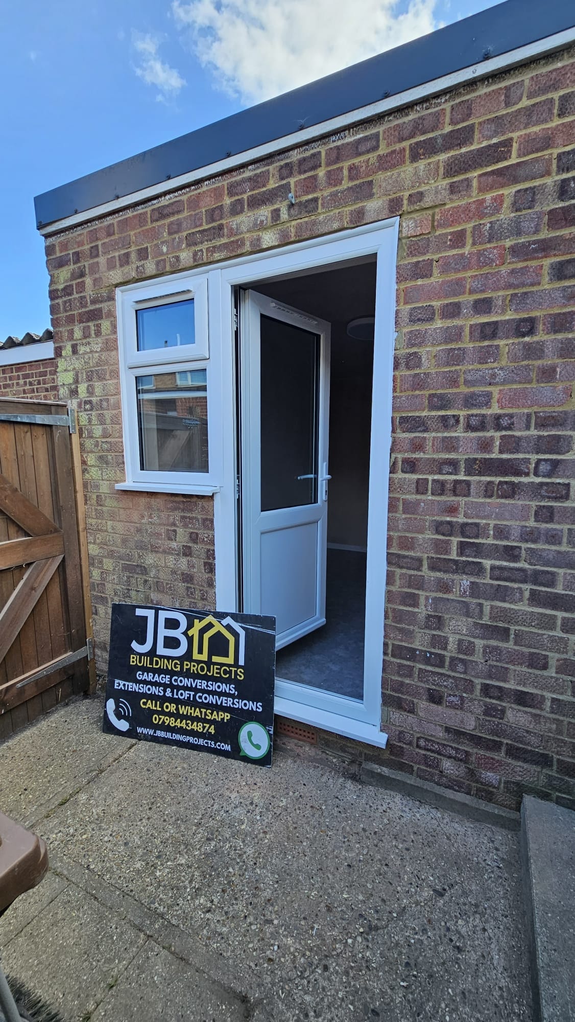 Completed exterior of the partial garage conversion with new PVC door and window open — Chelmsford