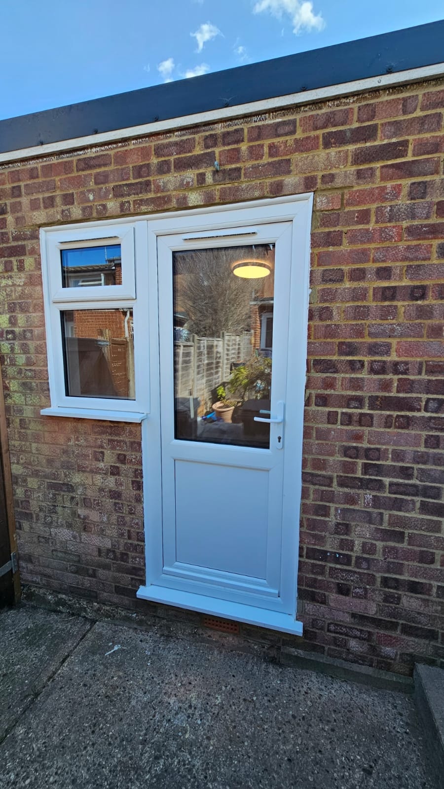 Completed exterior of the partial garage conversion with PVC door closed — Chelmsford