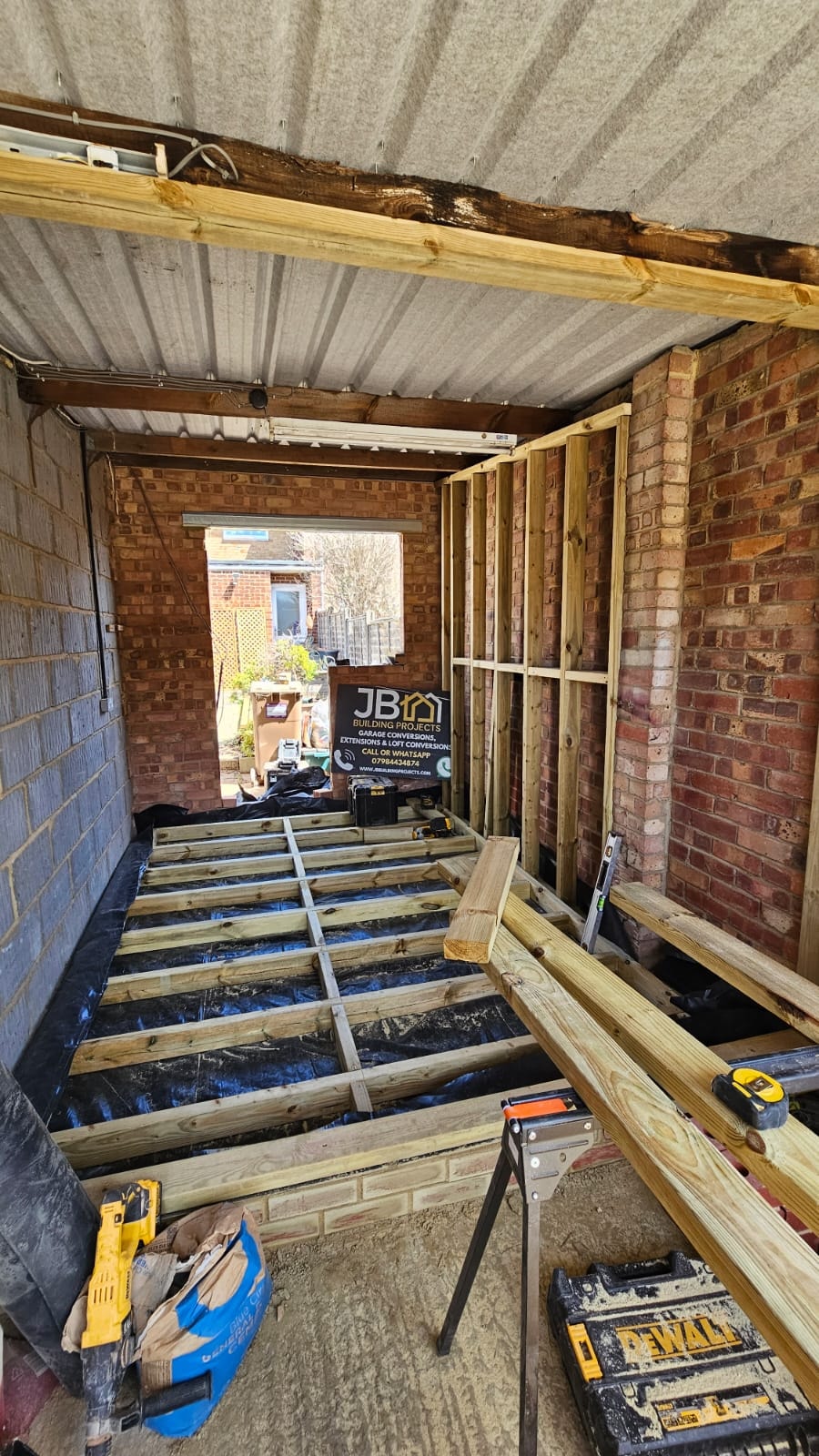 Low brick separation wall to DPC level, floor vapour barrier laid, and suspended timber floor framing — Chelmsford
