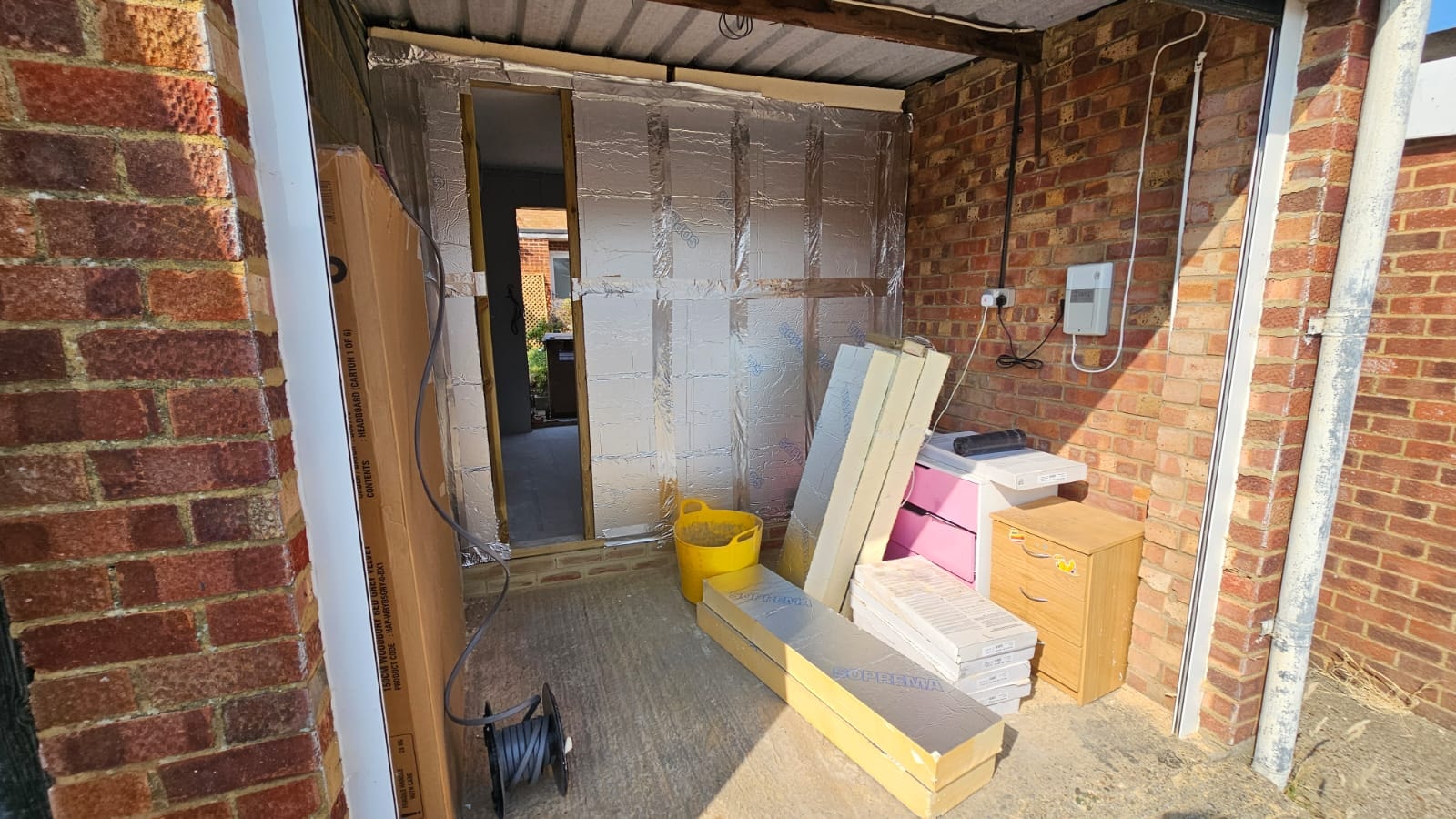 Retained front storage area and insulated dividing wall demonstrating the partial-conversion layout — Chelmsford