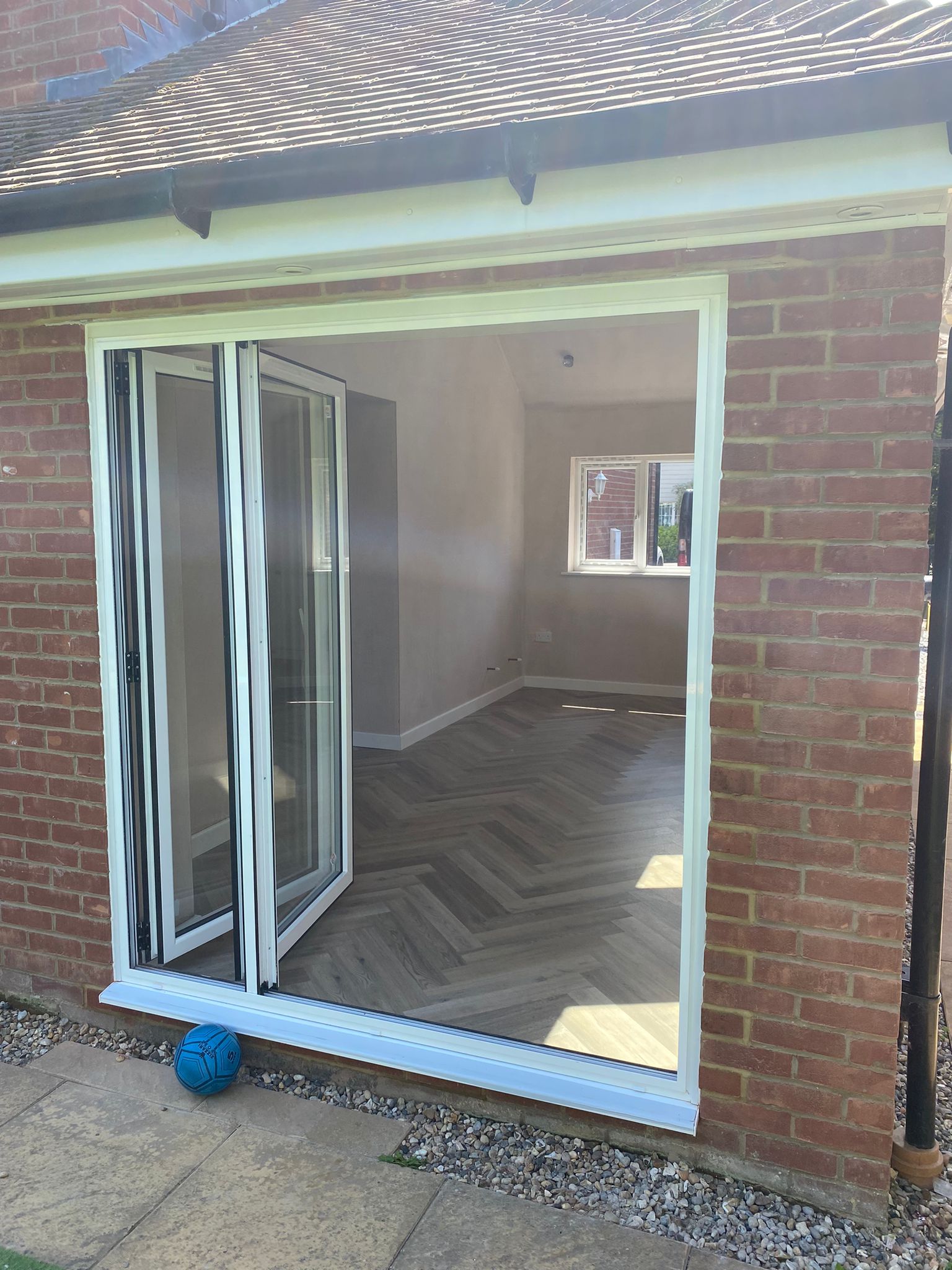 Completed single garage conversion — aluminium bifold doors, Huxley Close