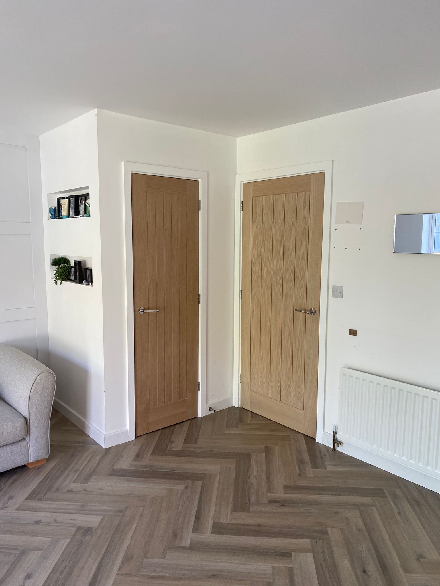 Completed single garage conversion — oak internal doors and herringbone LVT flooring, Huxley Close