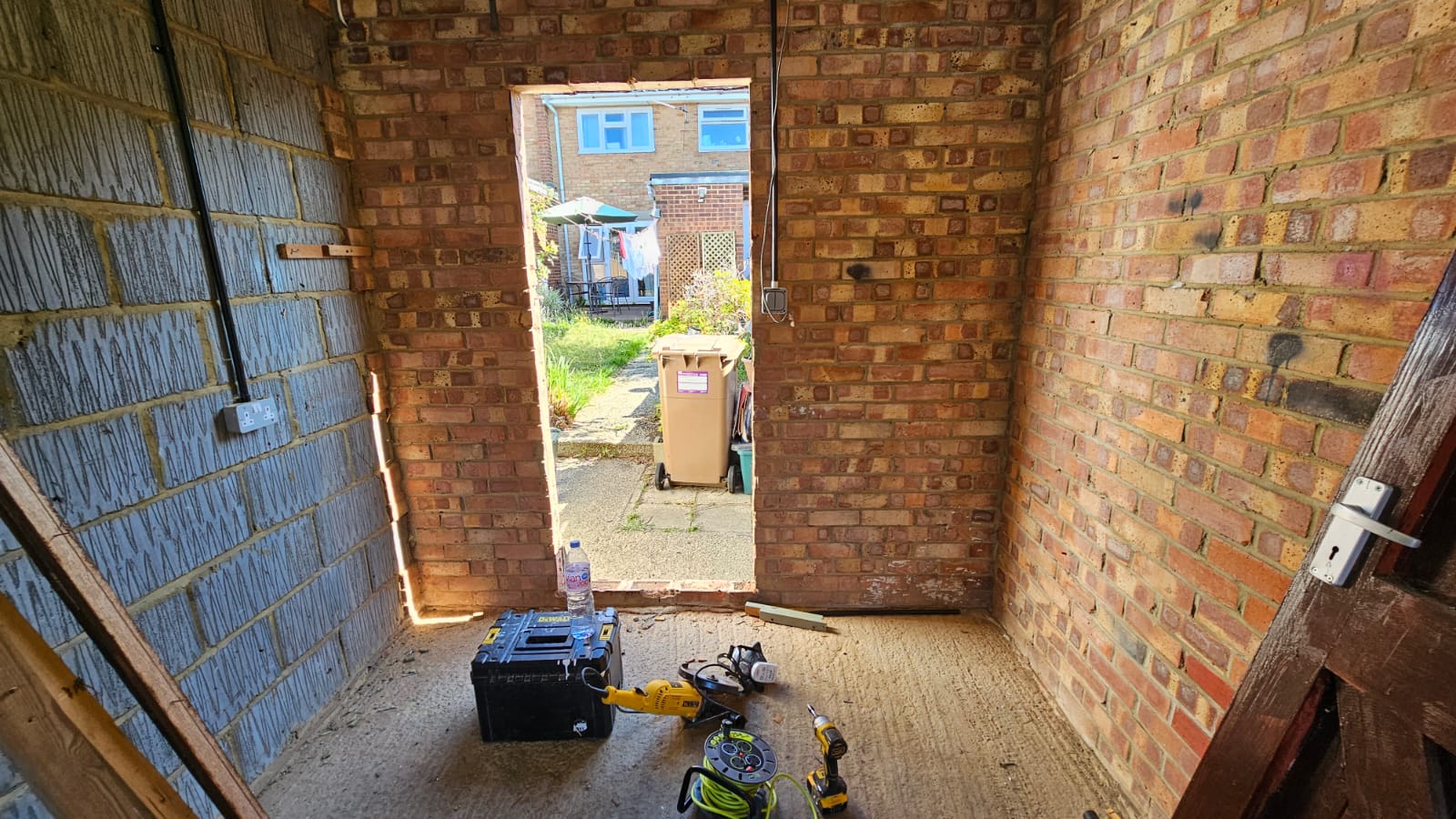 Original rear wall and narrow access door before enlargement — Chelmsford partial garage conversion