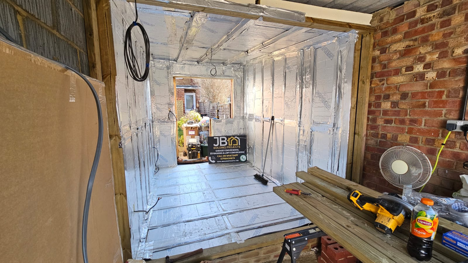 Foil-faced insulation fitted across the floor, walls and ceiling in a Chelmsford garage conversion