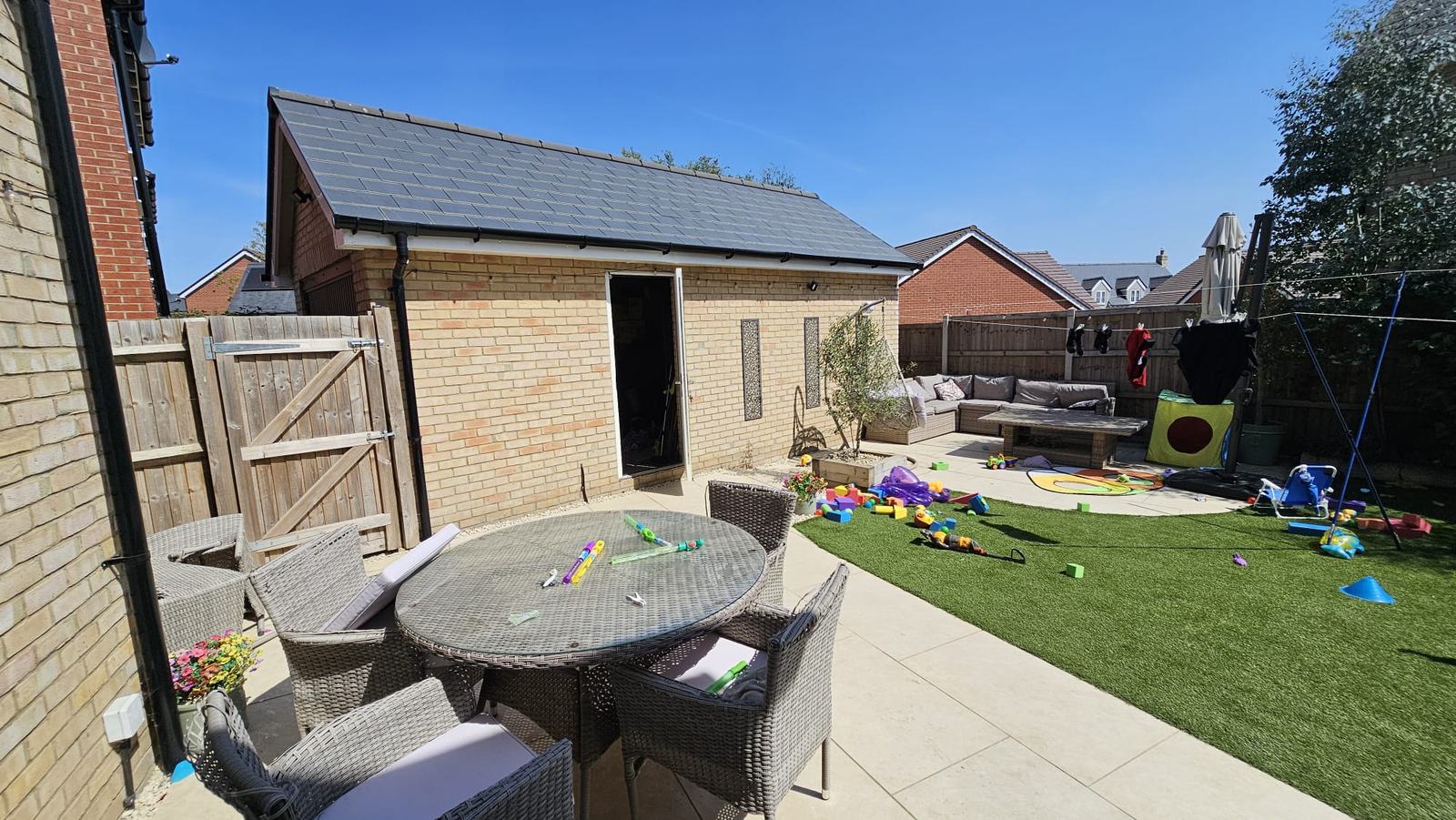 Garden-facing brick elevation of the detached garage in Dunmow before the office conversion
