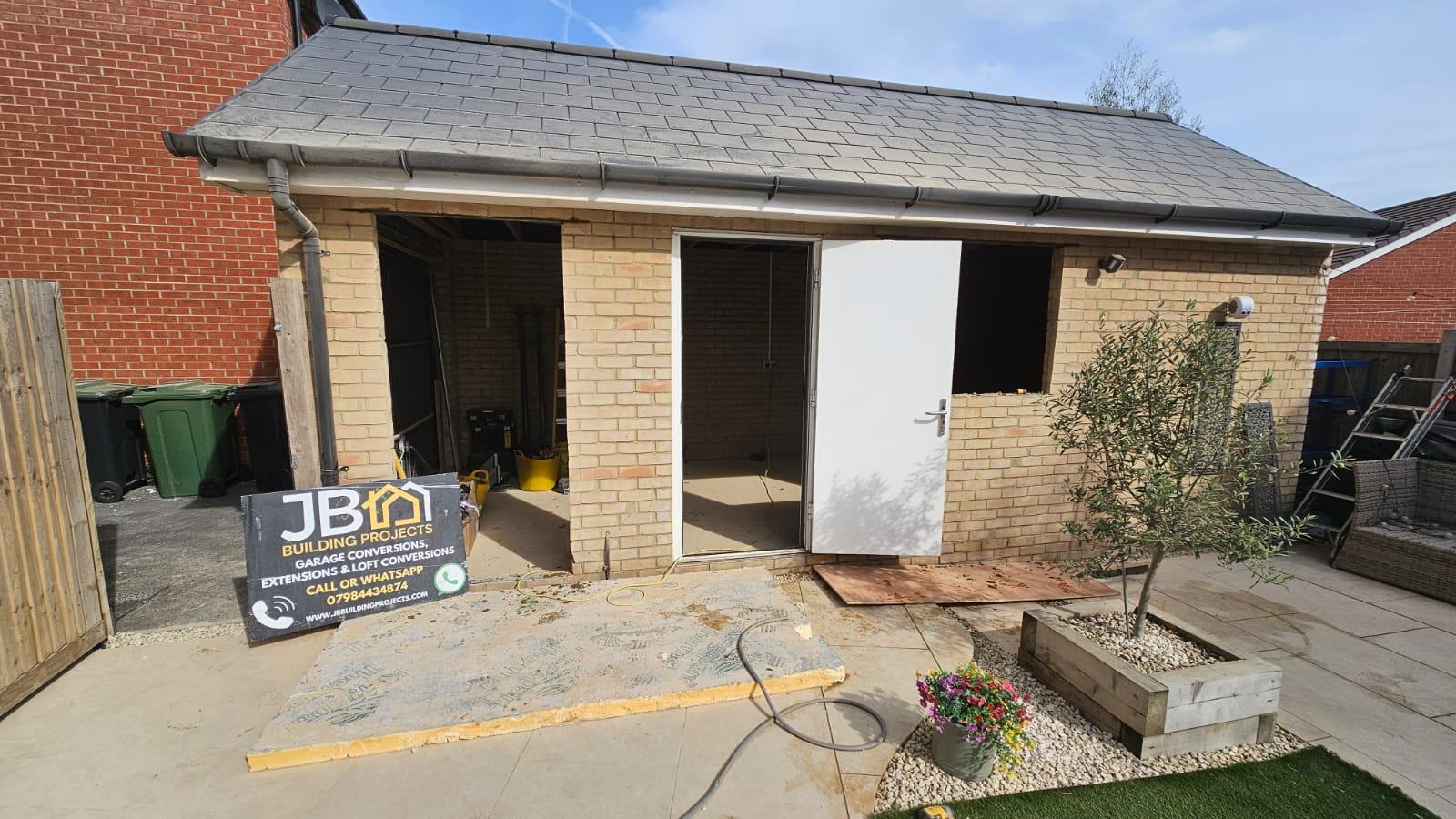 Wide view of the Dunmow detached garage exterior during the window and access-door works