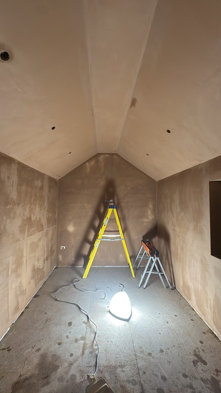 Freshly skimmed walls and vaulted ceiling in the Dunmow garage office before flooring and decoration