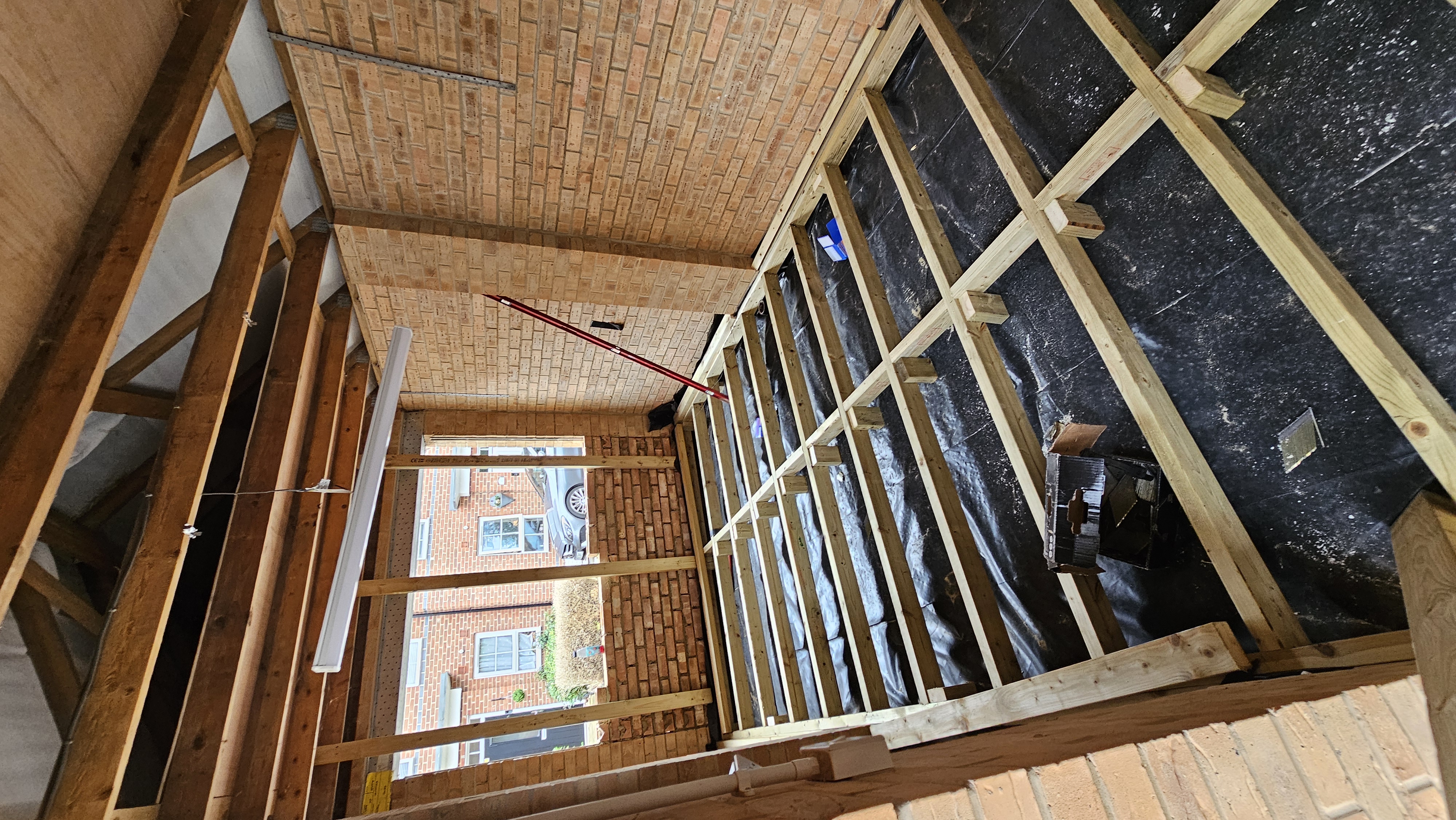 Treated timber raised-floor grid being built inside the detached garage