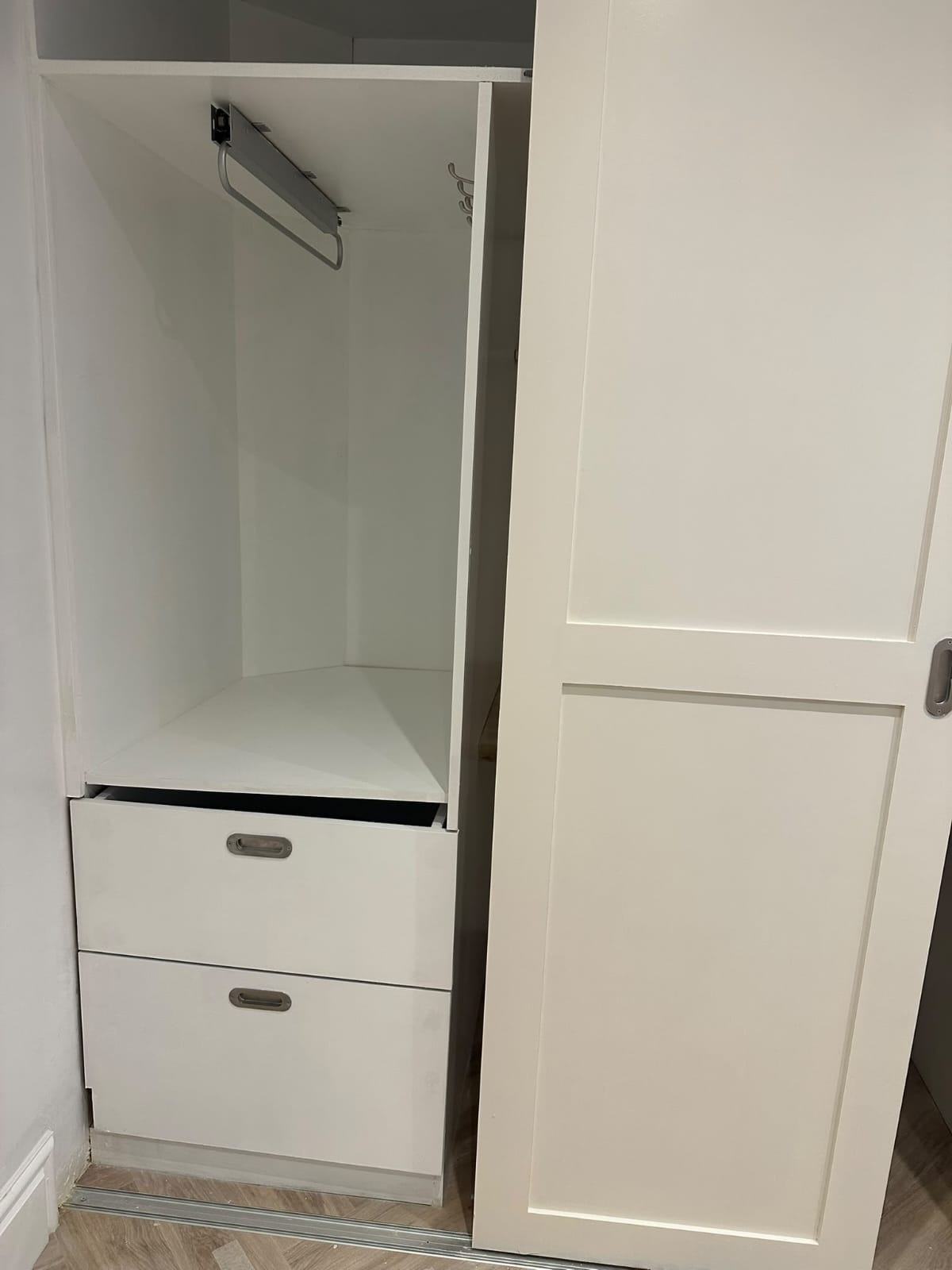 Detail of the white drawer unit and hanging rail inside the bespoke Waltham Cross office storage