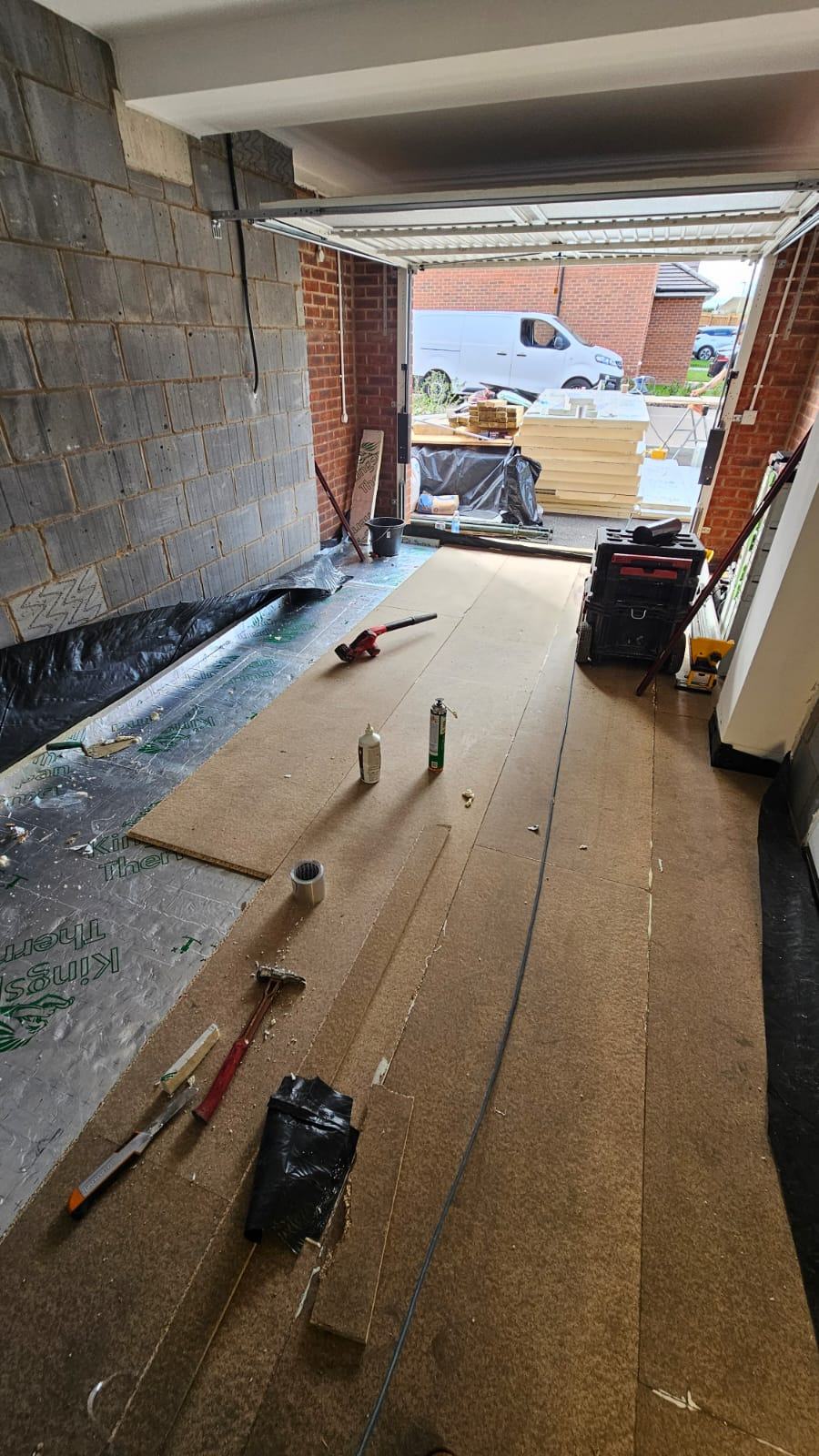 Timber floor decking being laid inside the Waltham Cross garage office during the early floor works