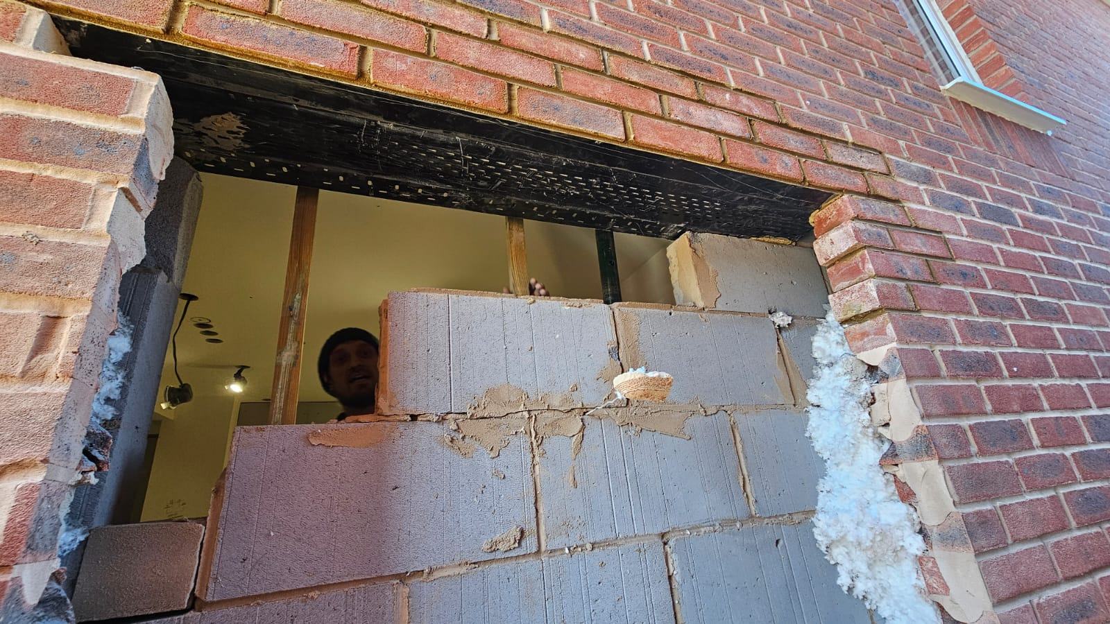Blockwork infill forming the lower part of the new window opening within the original garage frontage