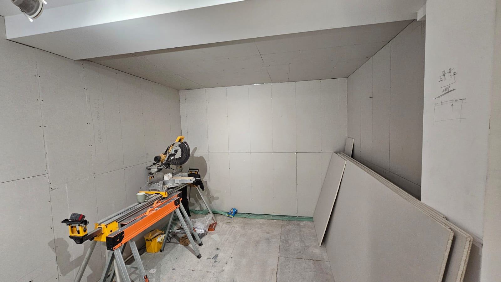 The Waltham Cross office lined with plasterboard around the window and ceiling before skim plaster