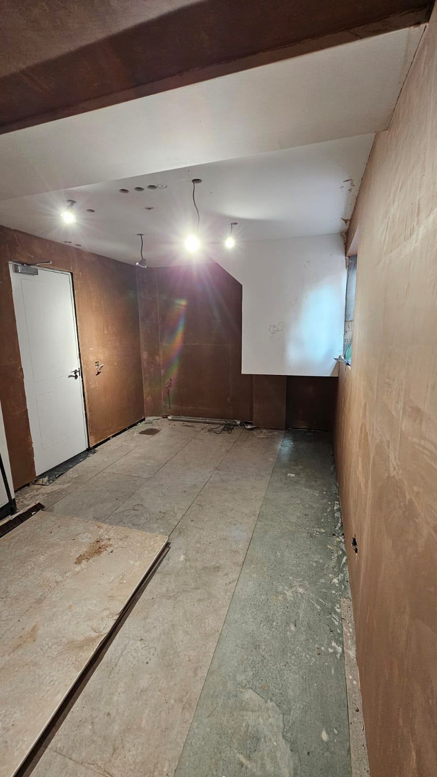 The plastered Waltham Cross garage office with lighting work in progress before final decoration and flooring